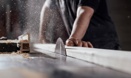 Man using a table saw to cut lumber